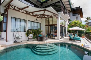 A modern house with a swimming pool, outdoor seating, and a covered patio area. - Stunning Ocean Views 6BR Villa w/ Private Pool & Sky Suite (Quepos)