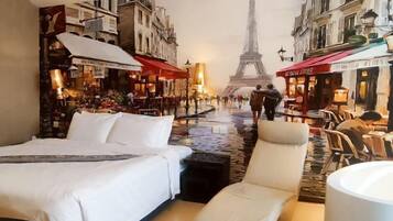 A hotel room with a bed, a chair, and a view of the Eiffel Tower through a mural.