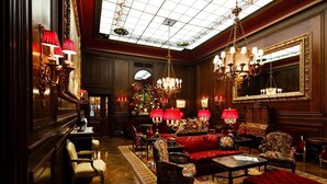 A luxurious lobby with ornate chandeliers, plush seating, and a large mirror. - Hotel Sacher Wien (Vienna)