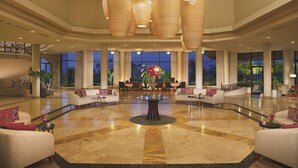 A spacious lobby with a central round table, multiple seating areas, and large windows offering views of the outdoors. - Dreams Playa Bonita Panama (Veracruz)