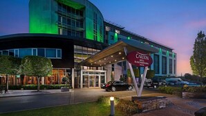 A hotel entrance with a curved facade, a covered entrance area, and a sign indicating the hotel name. - Carlton Hotel Blanchardstown (Dublin)