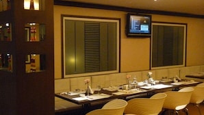 A conference room with a long table, chairs, and a screen displaying a presentation. - Mapple Express Bangalore (Bengaluru)