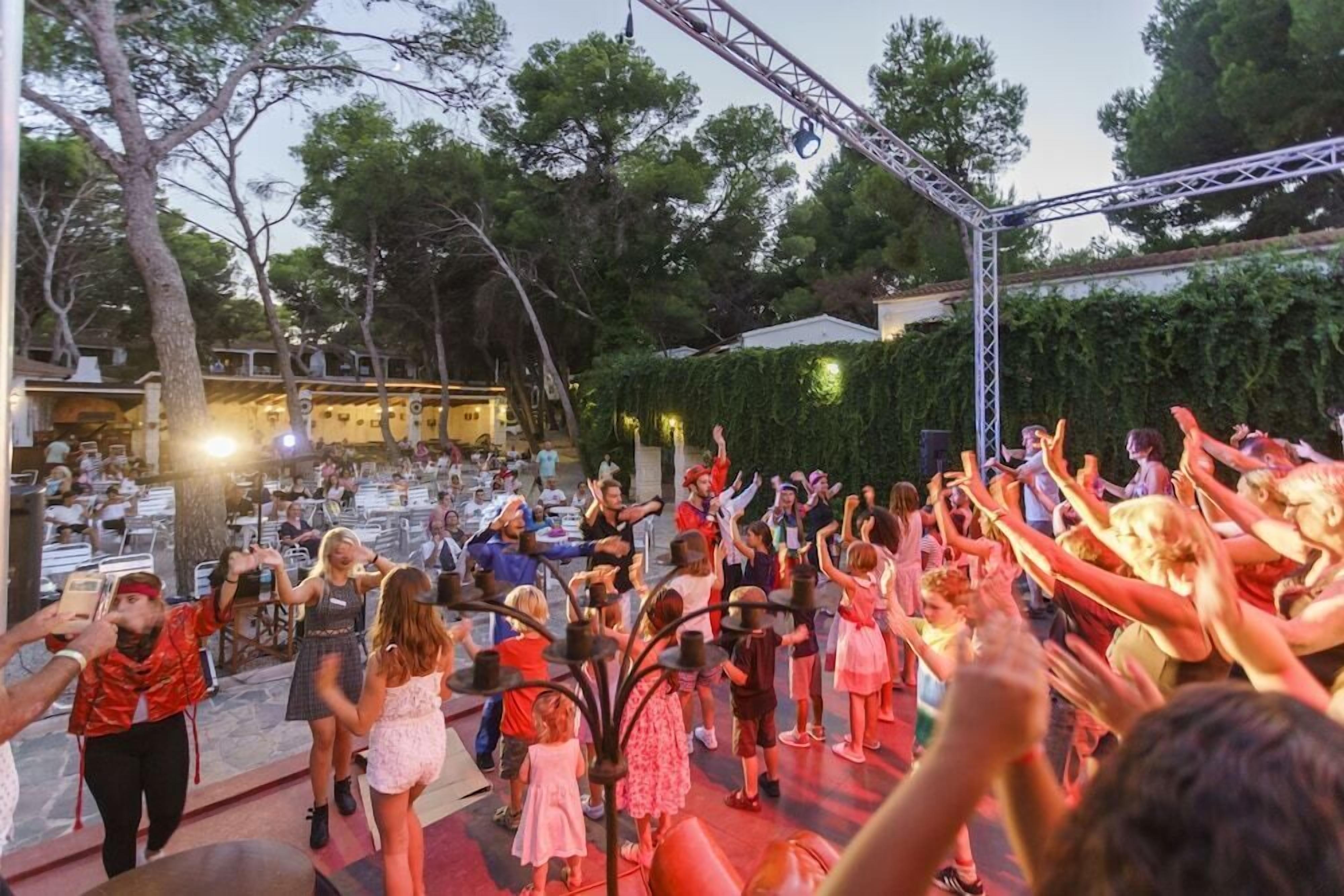 An outdoor event with a stage and audience.