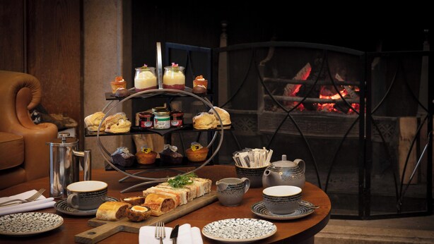 A dining table set with various food items, a coffee pot, and a tea set. - Murrayshall Country Estate (Perth)