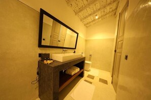 A modern bathroom with a large mirror, a sink, and a toilet. - Era Beach by Jetwing (Galle)