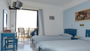 A hotel room with two beds, a desk with a chair, a television, and a painting on the wall. - Ostria Seaside Studios and Apartments (Chios)