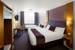 A hotel room with two beds, a desk, a TV, and a window with curtains. - Premier Inn Birmingham Central Hagley Road (Birmingham)