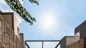 A modern building with a glass ceiling and a brick floor. - Comfort Vaggelis Studios (Hersonissos)