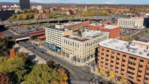 An urban area with a mix of modern and historic buildings, a prominent bridge, and a clear view of the surrounding landscape. - The Capitol Hotel, Ascend Hotel Collection (Hartford)