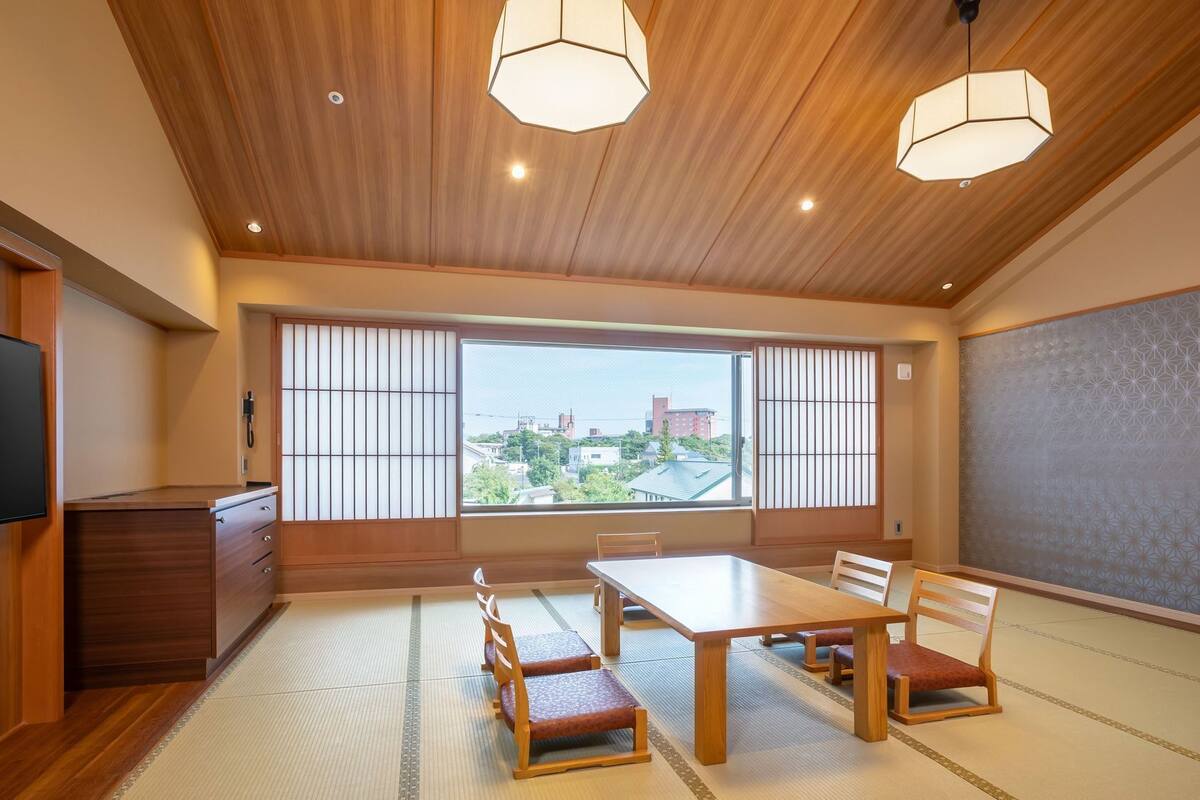 A traditional Japanese room with tatami flooring, a low table, and shoji screens.