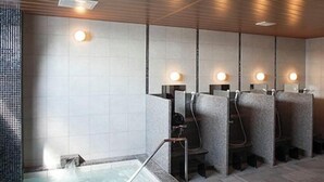 A spa area with a hot tub, individual seating, and wall-mounted lighting.
