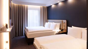 Hypo-allergenic bedding, desk, laptop workspace, blackout drapes