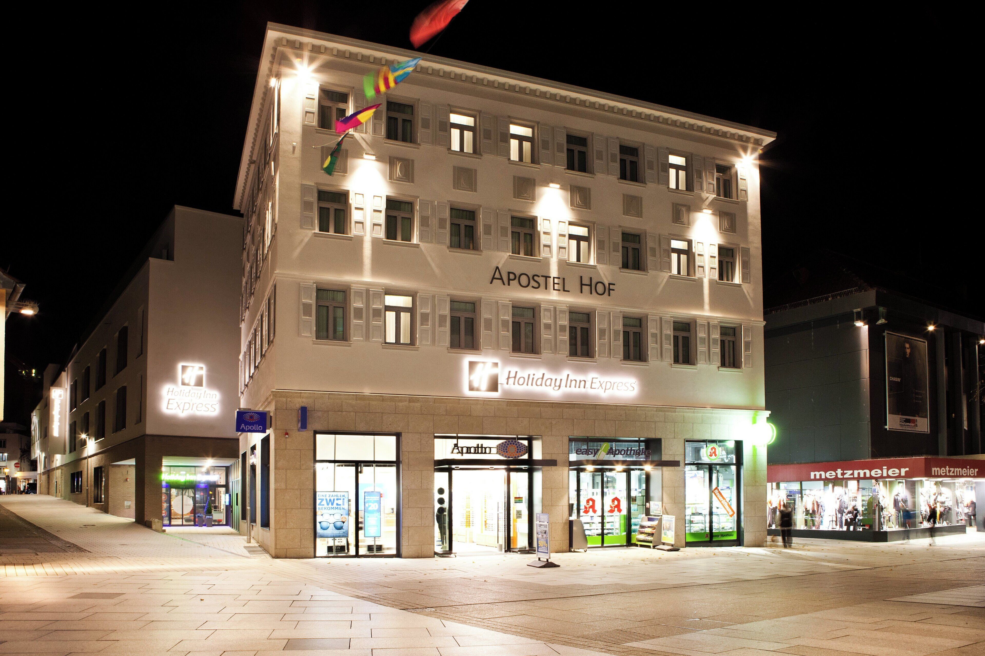A multi-story building with a sign for 'Holiday Inn Express' and 'Apollo' on the ground floor.
