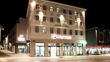 A multi-story building with a sign for 'Holiday Inn Express' and 'Apollo' on the ground floor.