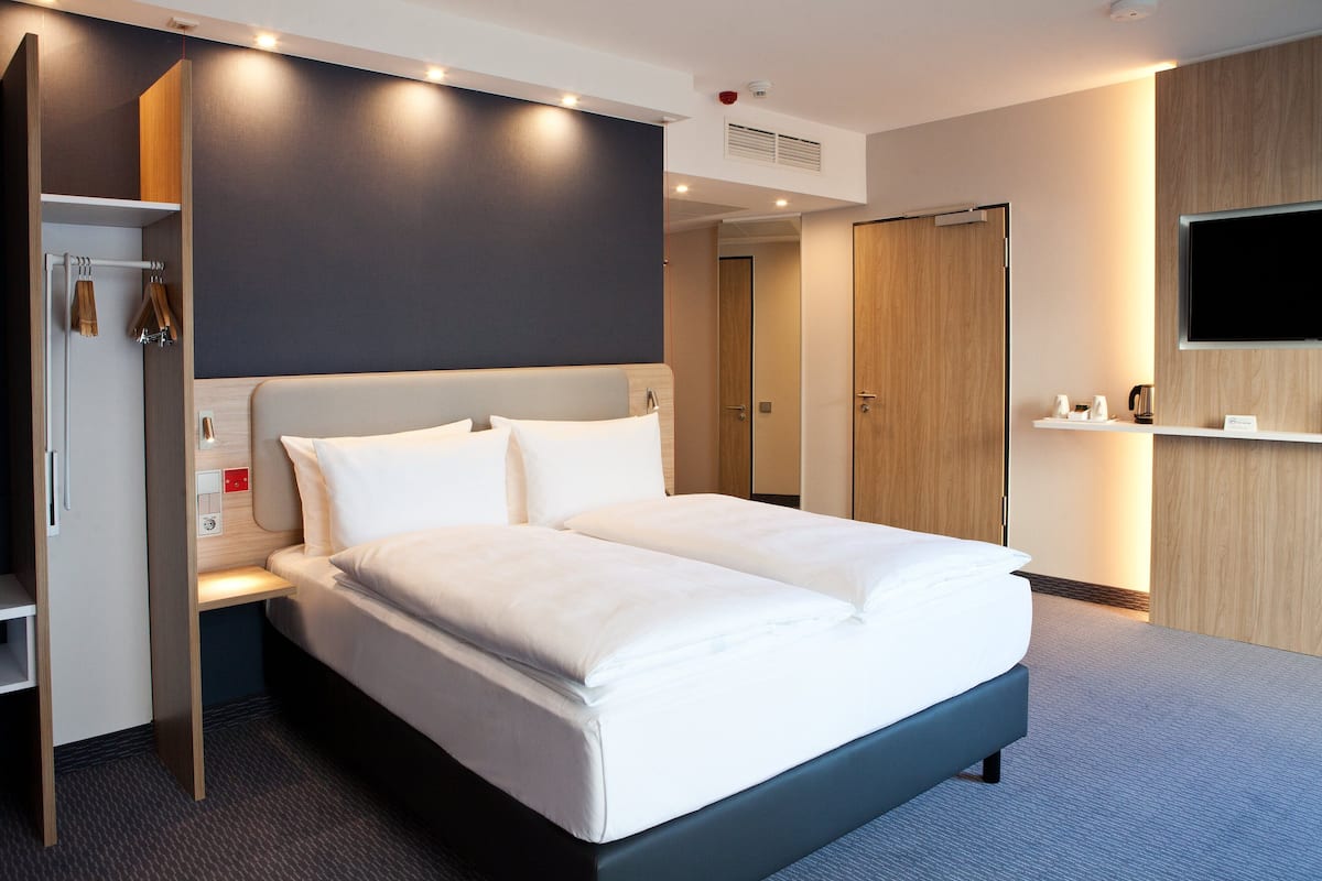 Hypo-allergenic bedding, desk, laptop workspace, blackout drapes
