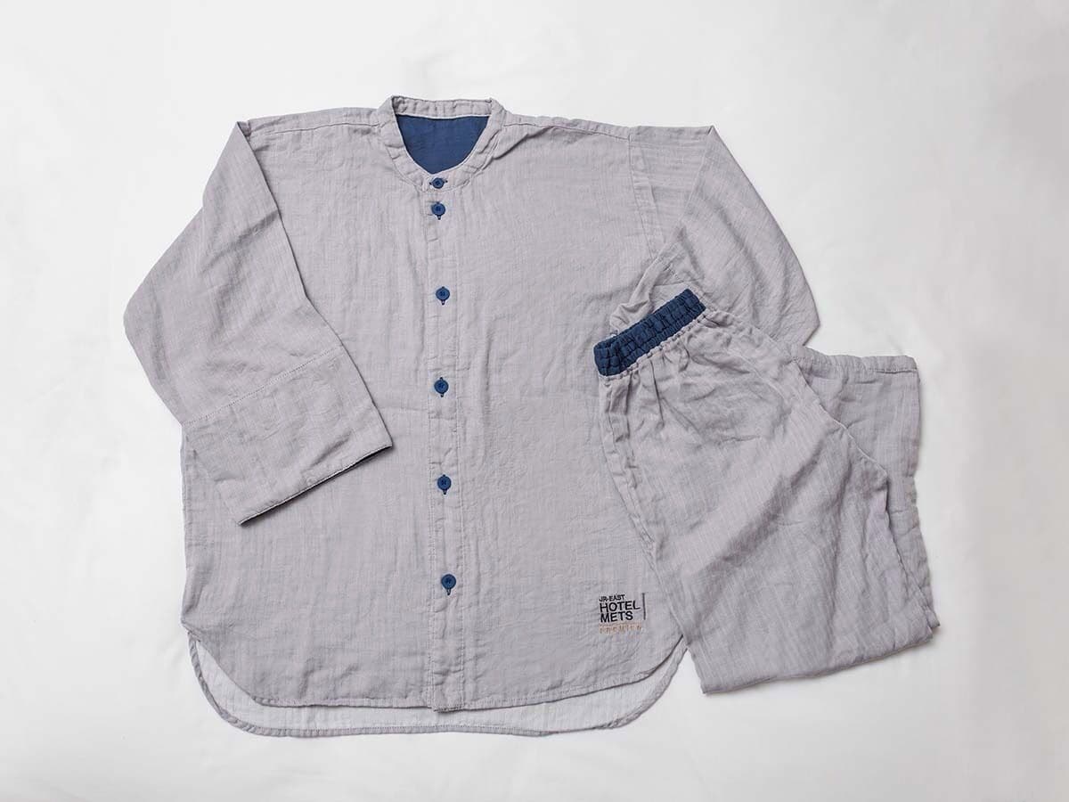 A light grey shirt with a collar, buttons, and a pocket on the left side.