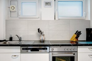 A modern kitchen with a built-in dishwasher, stove, and oven.