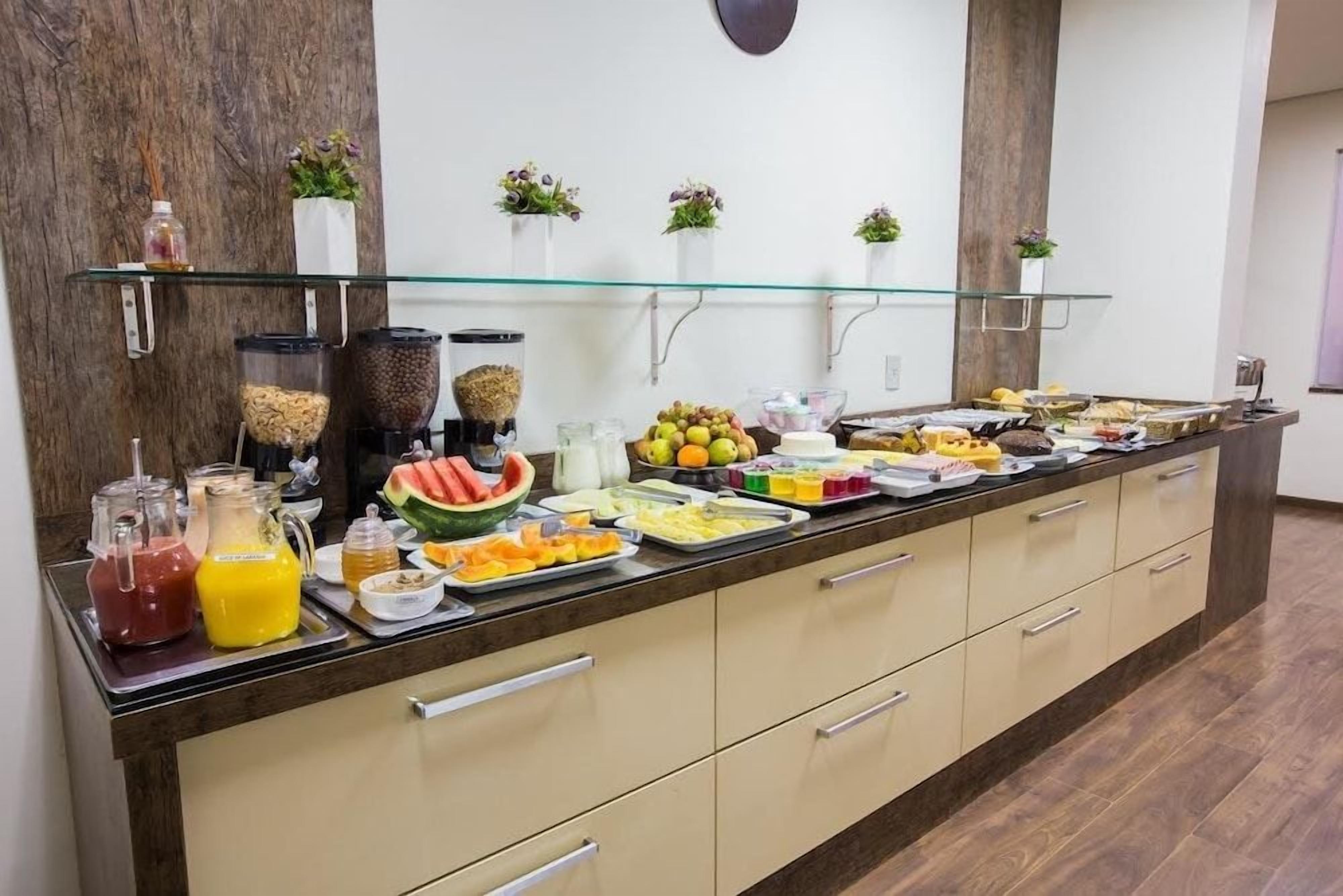A buffet with various food items and beverages.