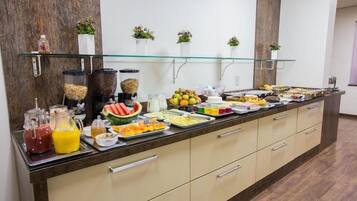 A buffet with various food items and beverages.