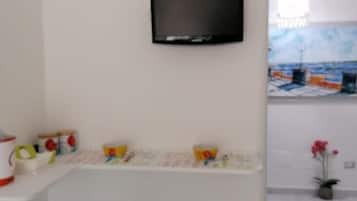 Relax in a stylish room with a flat-screen TV, bar area, and decorative shelf.
