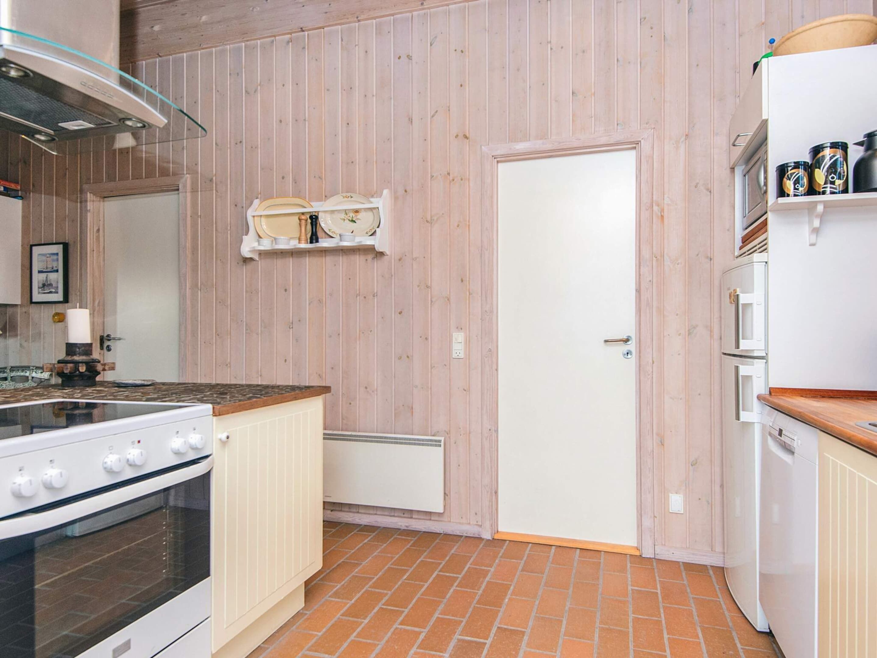 A kitchen with a stove, oven, and white cabinets.