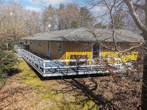 A wooden cabin with a porch, surrounded by trees. - Cozy Holiday Home in Graested near Sea (Graested)