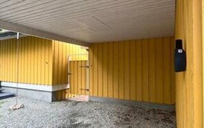 A building with a yellow exterior, a concrete base, and a gravel ground. - Cozy Holiday Home in Graested near Sea (Graested)