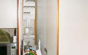 A laboratory with a microwave, a water dispenser, and various scientific equipment.