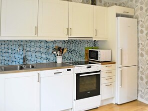 A kitchen with white cabinets, a Siemens microwave, a Siemens oven, and a Siemens dishwasher. - Holiday Home in Ljungskile (Ljungskile)