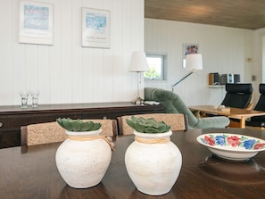 A dining table with two white ceramic vases with green plants, a floral bowl, and a lamp. - 4 Person Holiday Home in Borkop (Borkop)