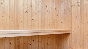 A wooden wall with a shelf and a workbench. - Cozy Holiday Home in Jutland near Beach (Hals)