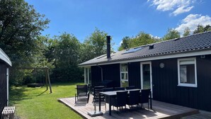 A house with a deck, outdoor furniture, and a chimney. - 4 Star Holiday Home in Tarm (Tarm)