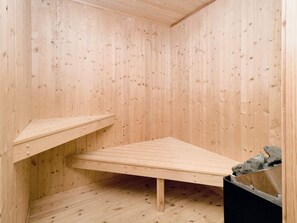 A room with wooden walls and a slanted ceiling.