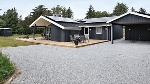 A modern building with a covered patio, a garage, and a number 16 sign. - 5 Star Holiday Home in Albaek (Aalbaek)