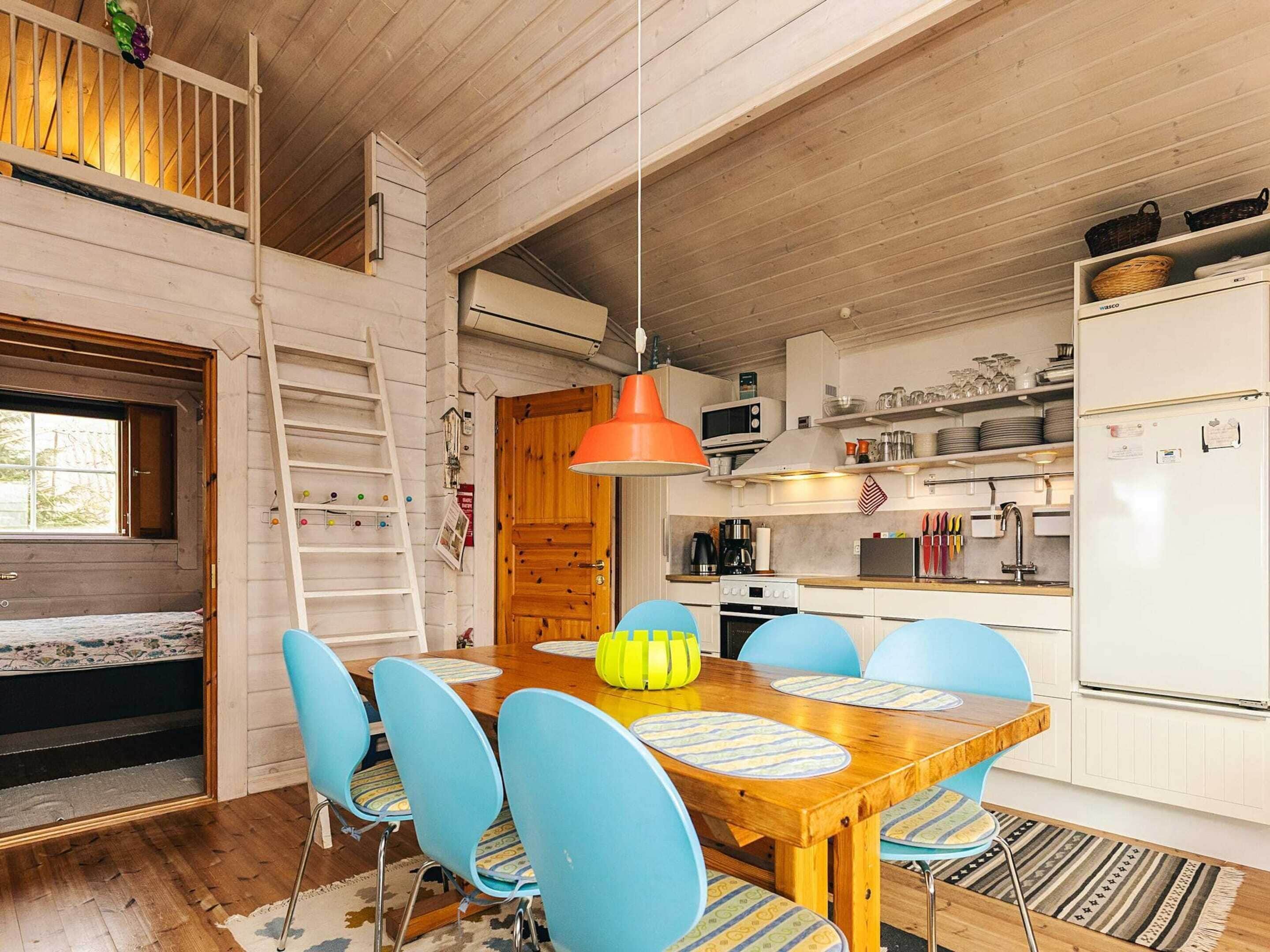 A compact kitchen with white cabinets, a microwave, and a refrigerator.