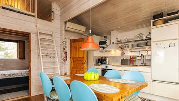 A compact kitchen with white cabinets, a microwave, and a refrigerator.