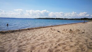 A sandy beach with calm water, a clear sky, and distant land. - 4 Star Holiday Home in Haderslev (Haderslev)