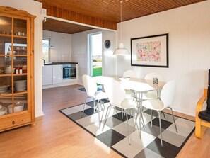 A modern kitchen with white cabinets, a black countertop, and a built-in oven. - 4 Person Holiday Home in Hejls-by Traum (Hejls)