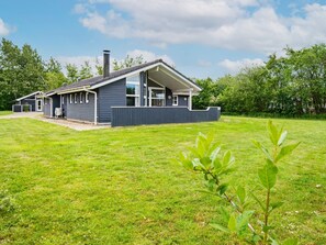 A two-story house with a covered porch and a chimney. - 4 Star Holiday Home in Hemmet (Hemmet)