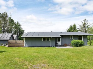 A single-story house with a grey exterior, a front porch, and a small front yard. - Spacious Holiday Home in Højslev near Sea (Hojslev)