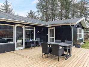 A modern house with a deck, large windows, and outdoor furniture. - 8 Person Holiday Home in Hals (Hals)