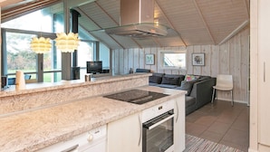 A modern kitchen with granite countertops, a built-in oven, and a large window. - 8 Person Holiday Home in Humble (Sydlangeland)