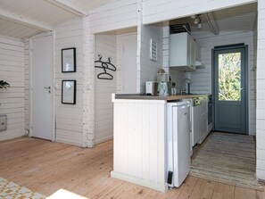 A compact kitchen with white cabinetry, a built-in dishwasher, and a small countertop. - 4 Person Holiday Home in Ebeltoft-by Traum (Ebeltoft)