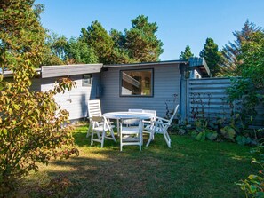 A small, single-story cabin with a patio area.