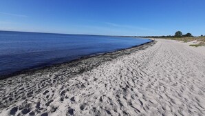 A sandy beach with a clear blue sky.
