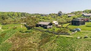 A residential area with houses surrounded by greenery, a clear sky, and a visible path. - 4 Star Holiday Home in Struer (Struer)