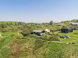 A residential area with houses surrounded by greenery, a clear sky, and a visible path. - 4 Star Holiday Home in Struer (Struer)