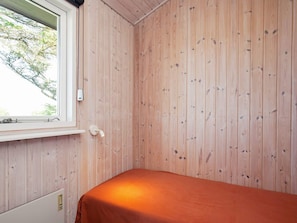A room with a single bed, a window, and wooden walls. - 4 Star Holiday Home in Struer (Struer)