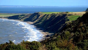 A coastal landscape with cliffs, a beach, and the ocean. - 4 Star Holiday Home in Struer (Struer)