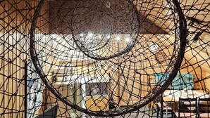 A circular net structure in a room with wooden walls and a visible ceiling. - 4 Person Holiday Home in Rebbenes (Tromsø)